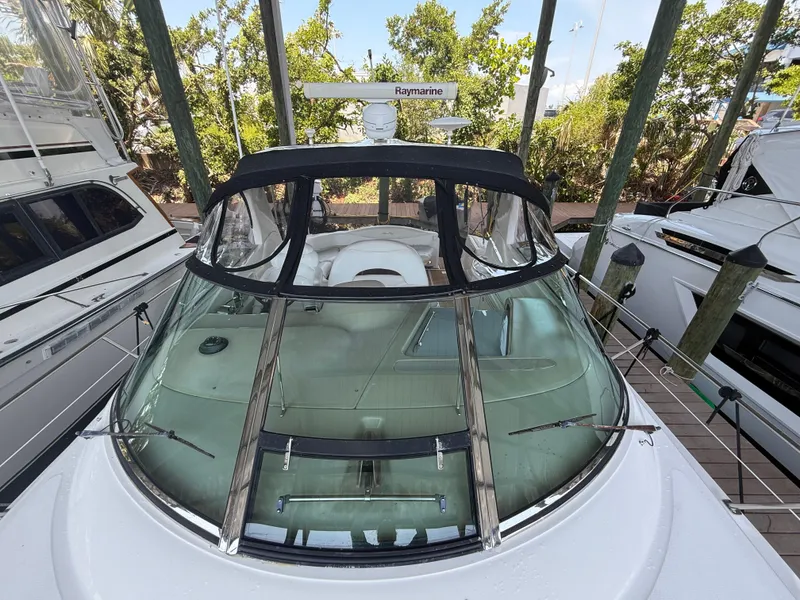 Slide: The Image of 2003 Sea Ray 380 Sundancer yacht docked, featuring sleek design and spacious cockpit. - 7