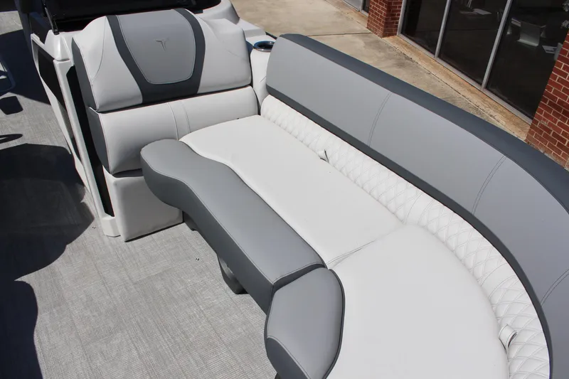 Slide: The Image of 2025 Tahoe Pontoon Cascade Quad Lounge Windshield interior with luxurious gray and white seating. - 10