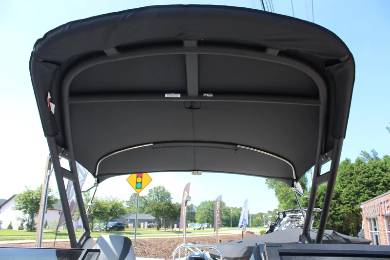 Slide: The Image of 2025 Tahoe Pontoon Cascade Quad Lounge Windshield with black canopy, viewed from below. - 16
