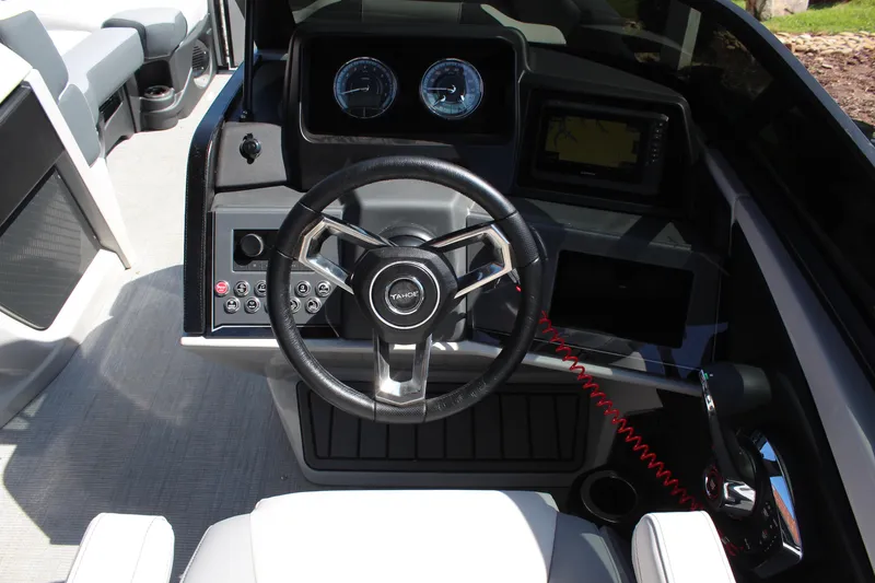 Slide: The Image of 2025 Tahoe Pontoon Cascade Quad Lounge Windshield dashboard with steering wheel and controls. - 8