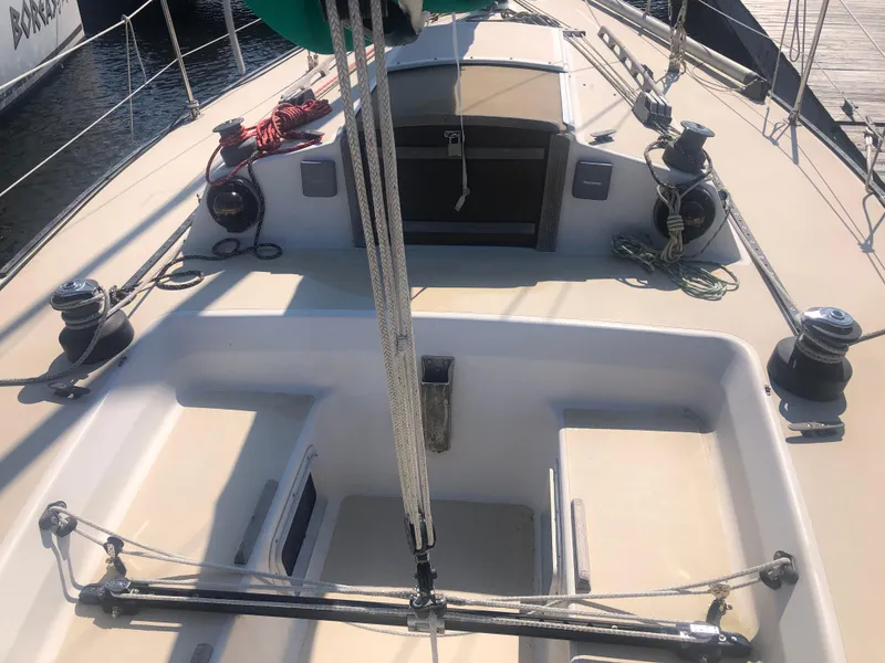 Slide: The Image of 1987 J Boats J29 sailboat cockpit with winches and ropes, docked at marina. - 10