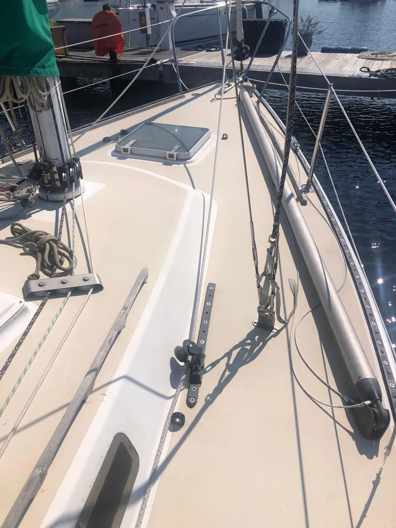 Slide: The Image of 1987 J Boats J29 sailboat deck with rigging and dock in background. - 12