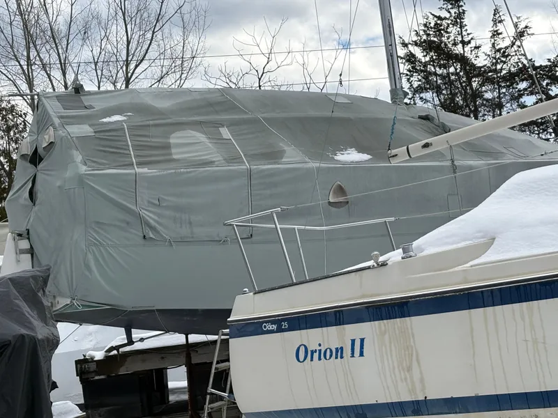 Slide: The Image of 1987 J Boats J29 sailboat covered in tarp, winter storage with snow. - 18