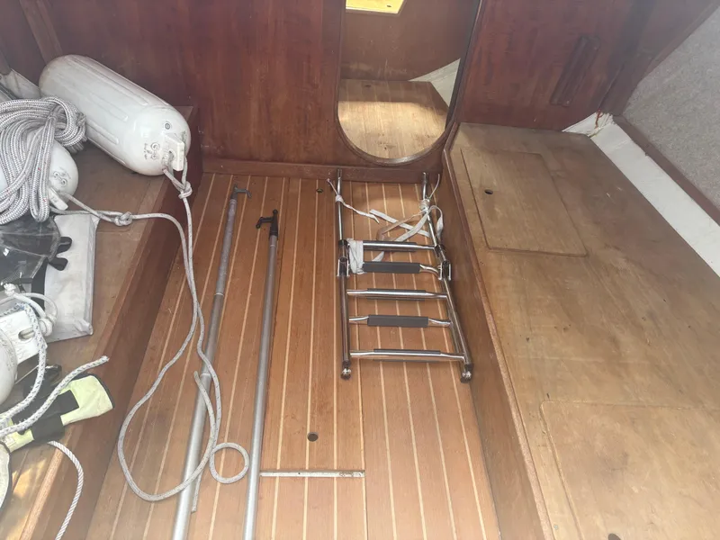 Slide: The Image of Interior of 1987 J Boats J29 sailboat with wooden flooring and nautical equipment. - 29