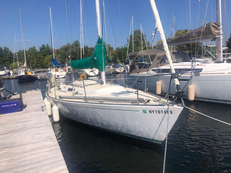 Slide: The Image of 1987 J Boats J29 sailboat docked at a marina on a sunny day. - 3
