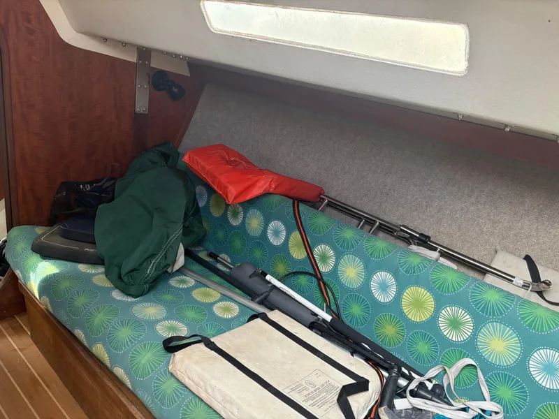 Slide: The Image of Interior of 1987 J Boats J29 with colorful cushions and sailing equipment. - 38