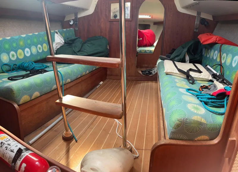 Slide: The Image of Interior of a 1987 J Boats J29 sailboat with colorful seating and nautical equipment. - 43