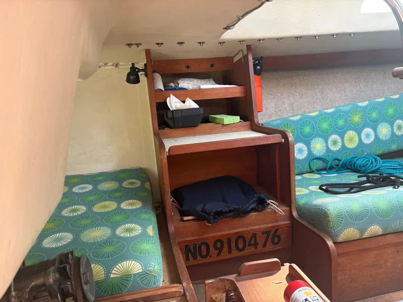 Slide: The Image of Interior of 1987 J Boats J29 sailboat with patterned cushions and storage shelves. - 45