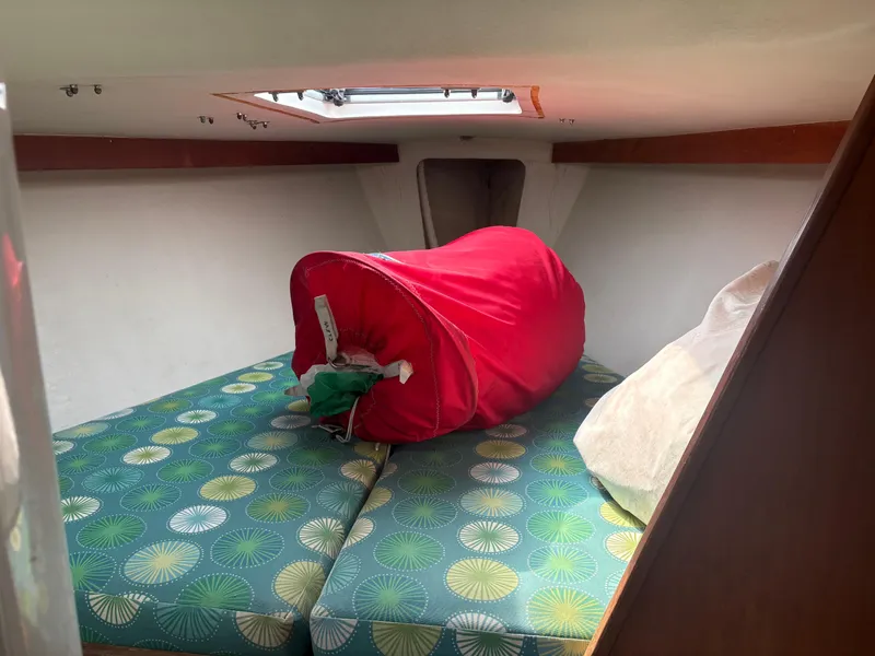 Slide: The Image of Interior of 1987 J Boats J29 with colorful cushions and red sail bag. - 48