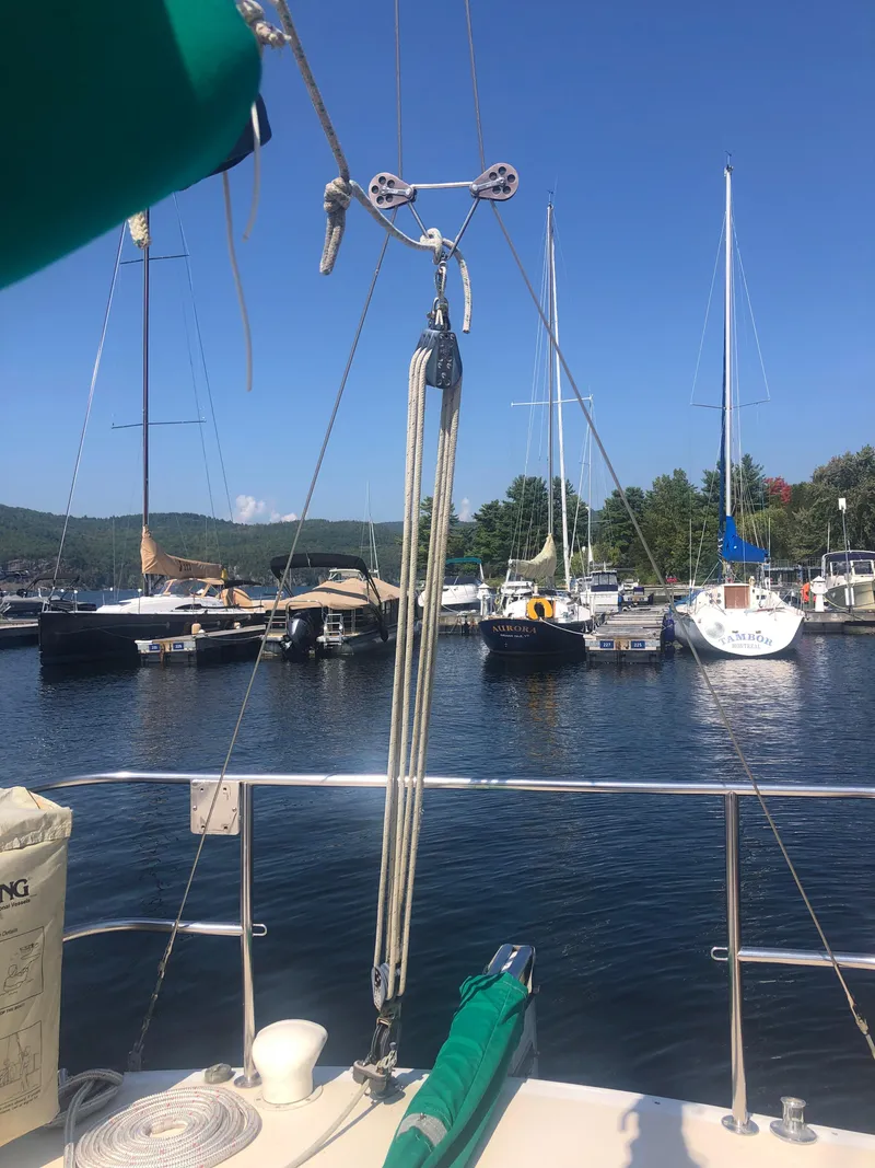 Slide: The Image of 1987 J Boats J29 sailboat docked in a marina with clear blue skies. - 7