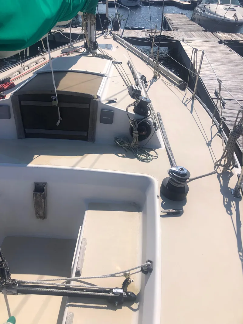 Slide: The Image of 1987 J Boats J29 sailboat deck with winches and green sail cover. - 9