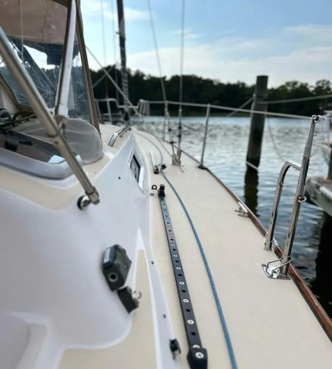 Slide: The Image of 2006 J Boats J/124 sailboat docked by the water on a sunny day. - 17
