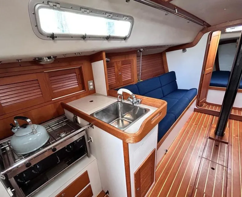 Slide: The Image of Interior of 2006 J Boats J/124 sailboat with kitchen and seating area. - 20