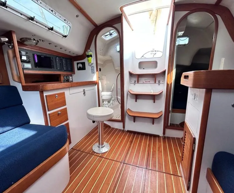 Slide: The Image of Interior of 2006 J Boats J/124 sailboat with wood accents and seating. - 24