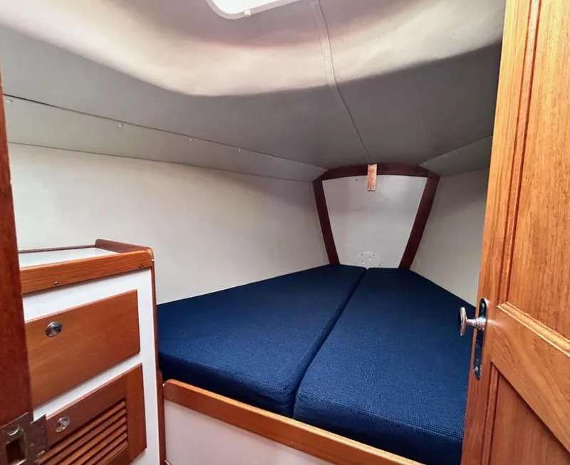 Slide: The Image of Cozy cabin interior of 2006 J Boats J/124 with blue cushions and wooden accents. - 27