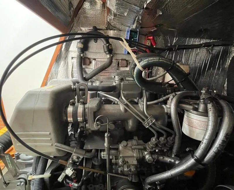 Slide: The Image of Engine compartment of a 2006 J Boats J/124 sailboat, showcasing detailed mechanical components. - 34