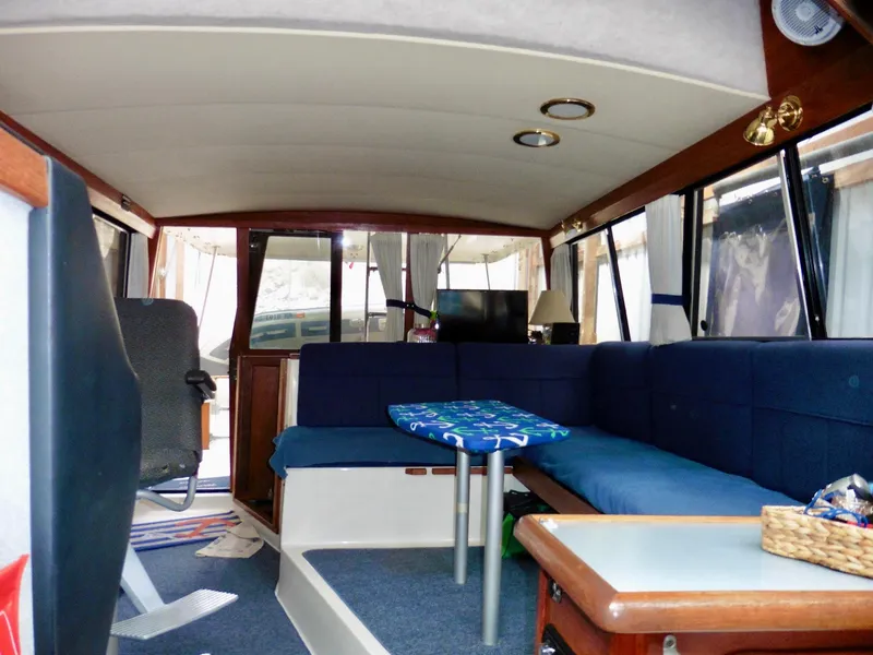 Slide: The Image of Interior of 1992 Bayliner 3288 Motoryacht with blue seating and wooden accents. - 11