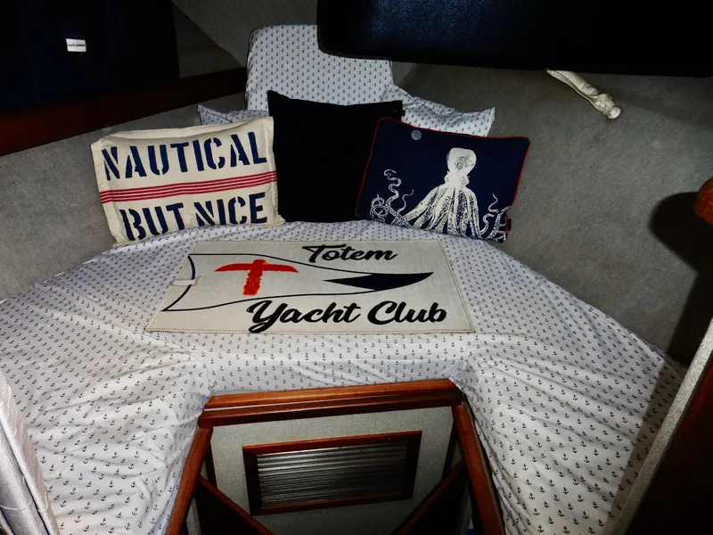 Slide: The Image of Cozy cabin interior of 1992 Bayliner 3288 Motoryacht with nautical-themed pillows. - 12