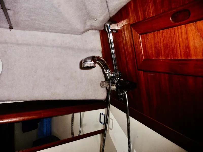 Slide: The Image of Interior of 1992 Bayliner 3288 Motoryacht showing shower fixture and wooden paneling. - 13