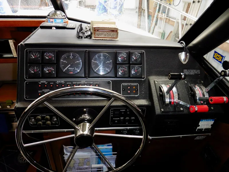 Slide: The Image of 1992 Bayliner 3288 Motoryacht helm with gauges, steering wheel, and throttle controls. - 20