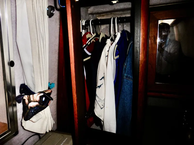 Slide: The Image of Clothes hanging in a closet aboard a 1992 Bayliner 3288 Motoryacht. - 23