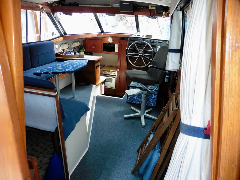Slide: The Image of Interior of 1992 Bayliner 3288 Motoryacht with helm, seating, and nautical decor. - 28