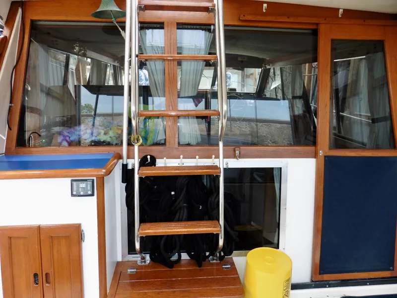 Slide: The Image of 1992 Bayliner 3288 Motoryacht interior with wooden stairs and nautical decor. - 33
