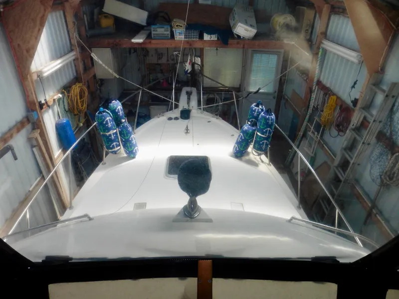 Slide: The Image of 1992 Bayliner 3288 Motoryacht in storage, with nautical-themed fenders and organized equipment. - 34