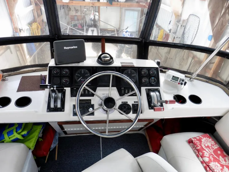 Slide: The Image of 1992 Bayliner 3288 Motoryacht helm with steering wheel, gauges, and navigation equipment. - 38