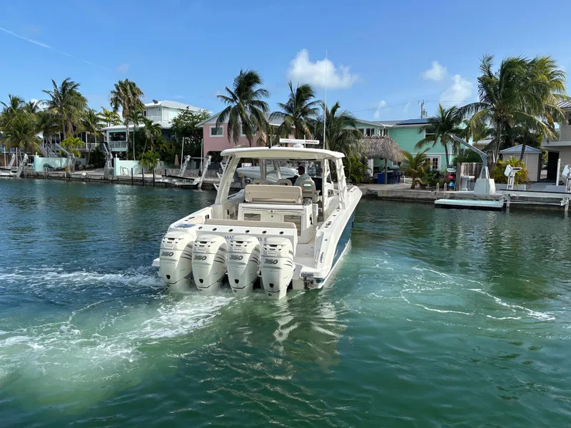 Slide: The Image of 2017 Boston Whaler 420 Outrage cruising in tropical waters near palm-lined shore. - 11