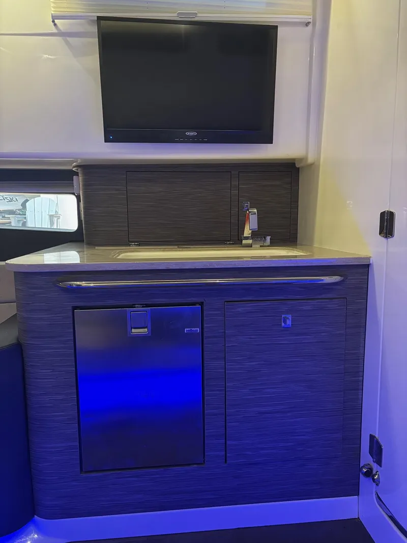 Slide: The Image of Interior of 2017 Boston Whaler 420 Outrage with kitchenette and TV. - 17