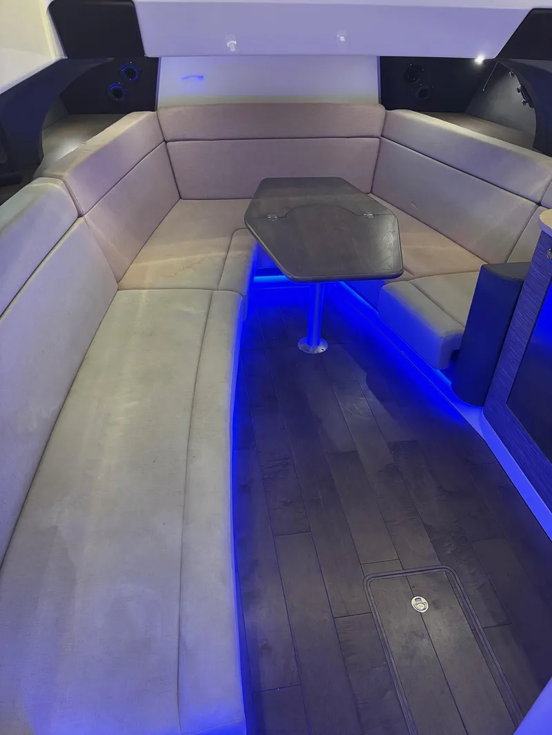 Slide: The Image of Interior of 2017 Boston Whaler 420 Outrage with blue LED lighting and cushioned seating. - 19