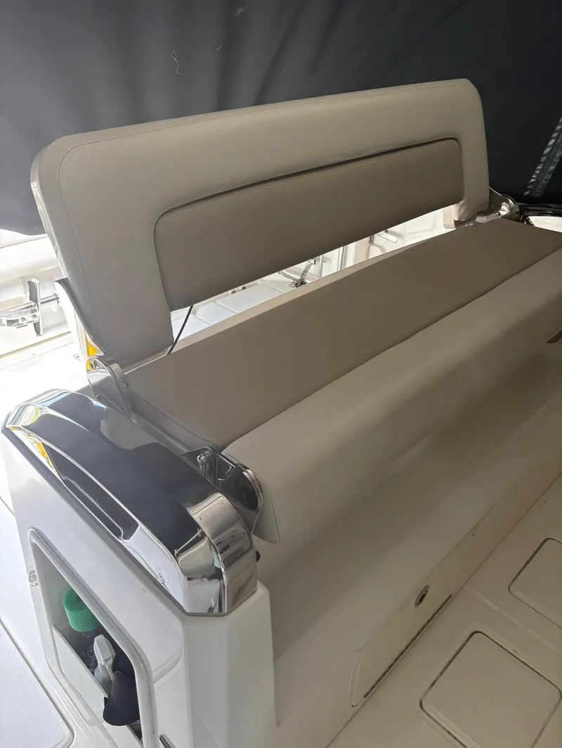 Slide: The Image of Boston Whaler 420 Outrage 2017 boat seat with beige upholstery and chrome accents. - 21