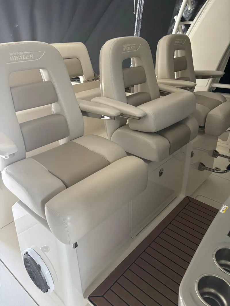 Slide: The Image of 2017 Boston Whaler 420 Outrage boat seats, featuring luxurious beige upholstery and armrests. - 22