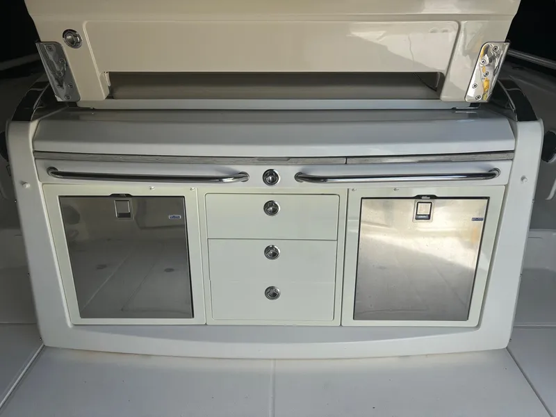 Slide: The Image of 2017 Boston Whaler 420 Outrage boat interior with storage compartments and drawers. - 28