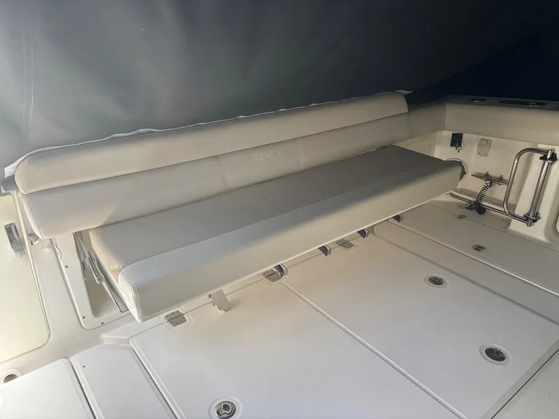 Slide: The Image of 2017 Boston Whaler 420 Outrage boat interior with cushioned seating and storage compartments. - 32
