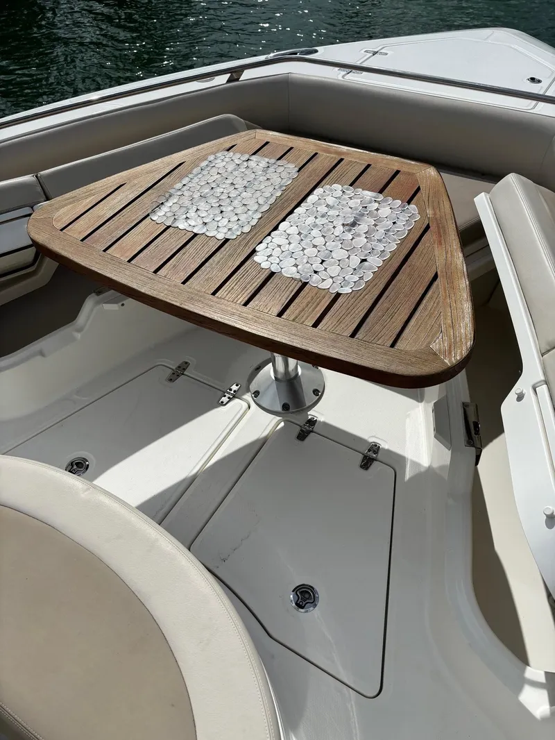 Slide: The Image of Luxury seating area on 2017 Boston Whaler 420 Outrage with wooden table. - 40