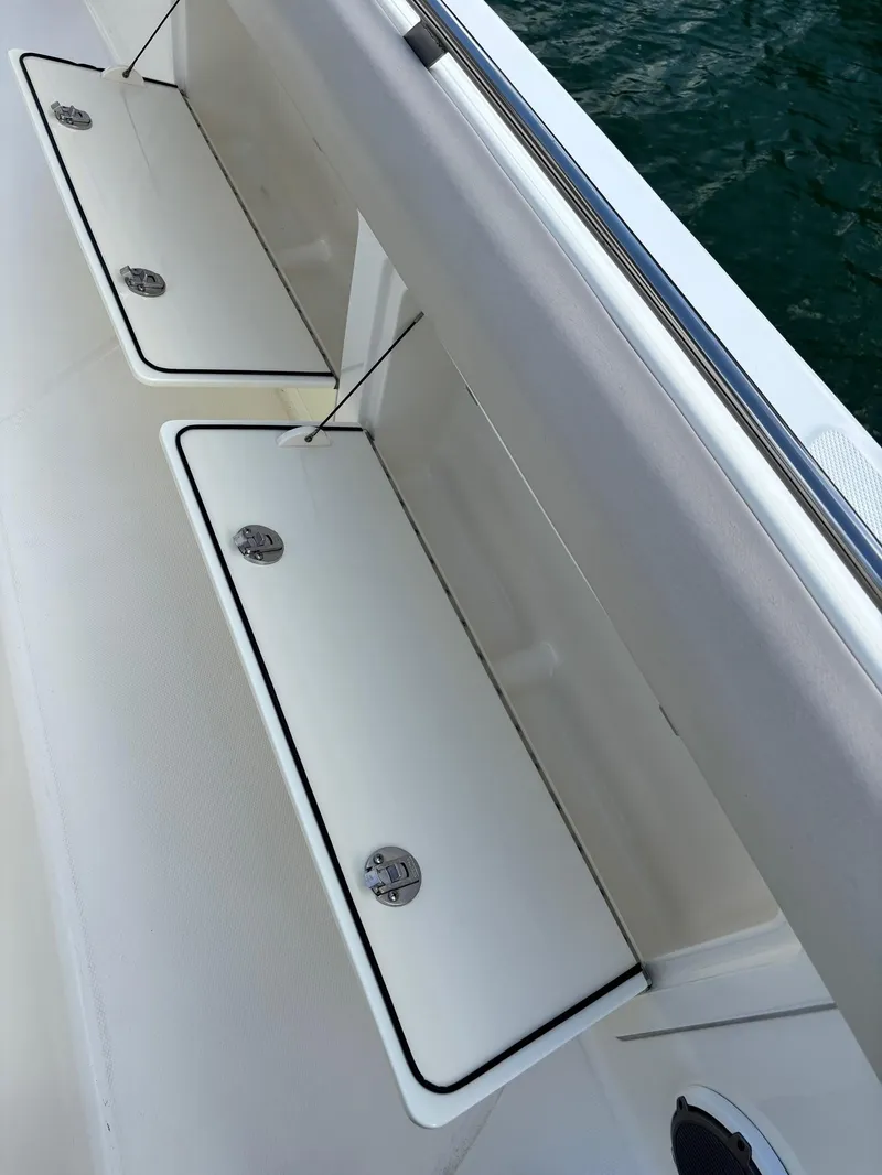 Slide: The Image of 2017 Boston Whaler 420 Outrage deck storage compartments, open on a sunny day. - 43