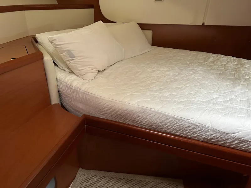 Slide: The Image of Cozy cabin interior of 2008 Beneteau Oceanis 46 yacht with wooden finish and white bedding. - 35