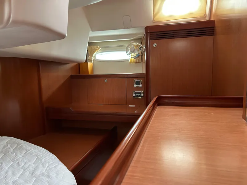 Slide: The Image of Interior cabin of 2008 Beneteau Oceanis 46 yacht with wooden furnishings and porthole. - 36