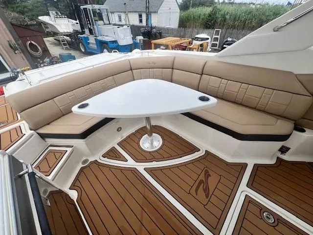 Slide: The Image of Luxurious seating area on 2016 Sea Ray 350 SLX boat with elegant wood flooring. - 10
