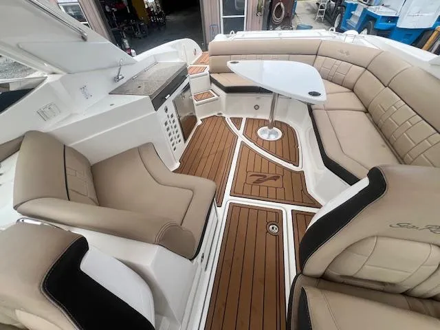 Slide: The Image of Luxurious interior of 2016 Sea Ray 350 SLX boat with beige seating and wooden flooring. - 14