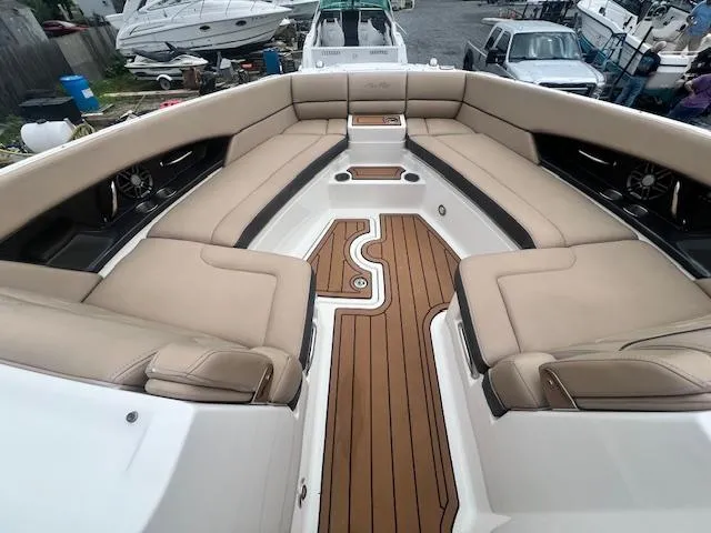 Slide: The Image of Luxurious 2016 Sea Ray 350 SLX boat interior with beige seating and wooden flooring. - 18