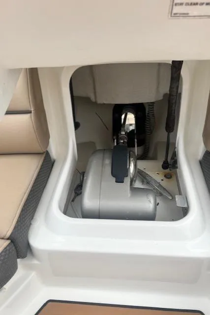 Slide: The Image of 2016 Sea Ray 350 SLX boat storage compartment with beige seating and visible equipment. - 19