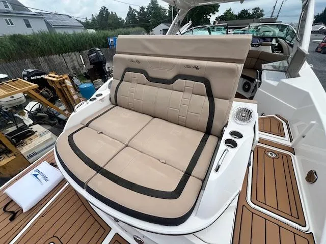 Slide: The Image of 2016 Sea Ray 350 SLX boat with tan cushioned seating and teak flooring. - 22