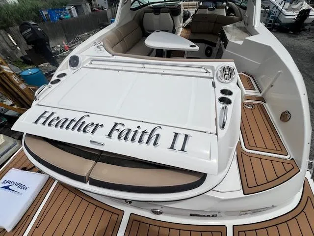 Slide: The Image of 2016 Sea Ray 350 SLX boat with teak deck and seating area. - 23