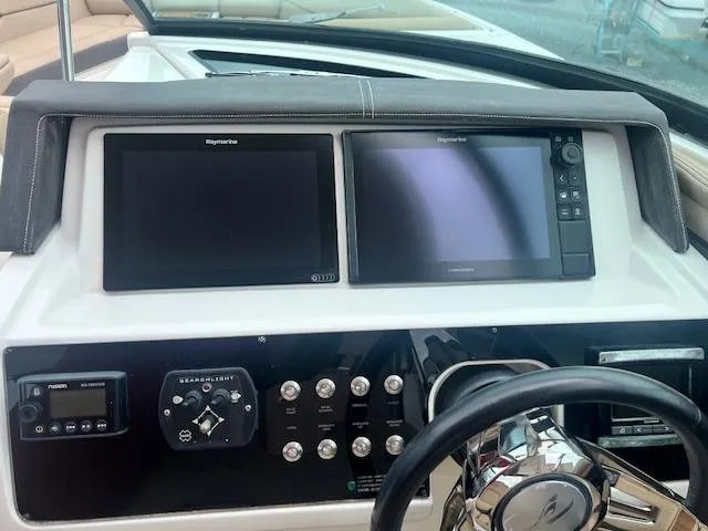 Slide: The Image of Control panel of 2016 Sea Ray 350 SLX boat with dual screens and steering wheel. - 4