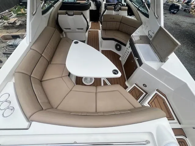 Slide: The Image of 2016 Sea Ray 350 SLX boat interior with beige seating and a white table. - 8