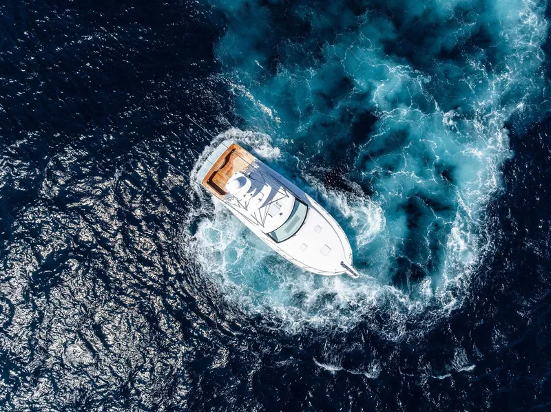 Slide: The Image of Aerial view of 2016 Hatteras Express Sportfish yacht navigating ocean waters. - 12
