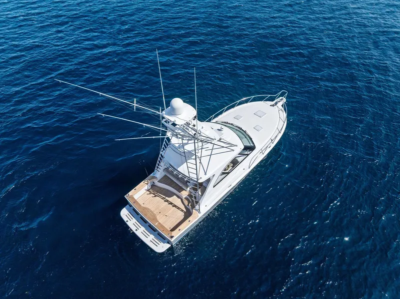 Slide: The Image of 2016 Hatteras Express Sportfish yacht on open blue sea, aerial view. - 15